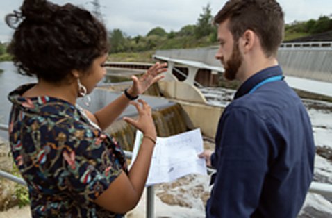 Engineers discussing plans on site